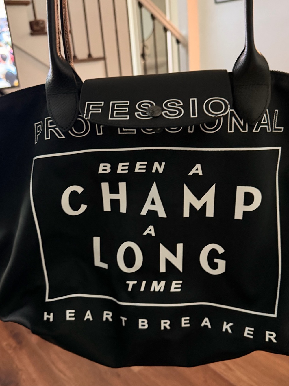 This is a limited-edition Longchamp x Emotionally Unavailable (EU) Le Pliage tot